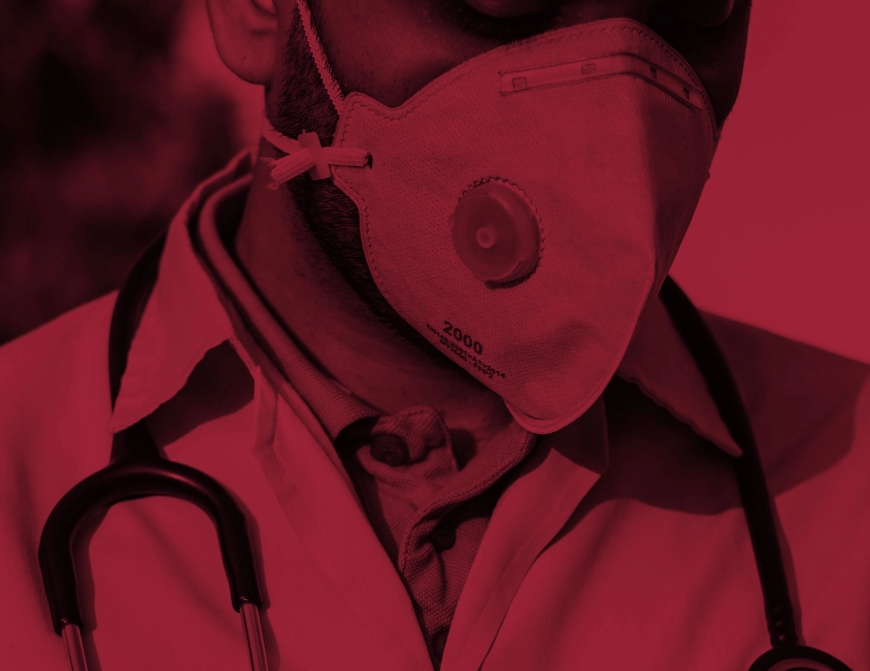 zoomed in image of a male physician wearing a protective face mask with red color overlay