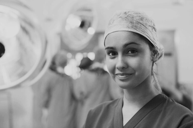 portrait of a young female clinician wearing a hair cap