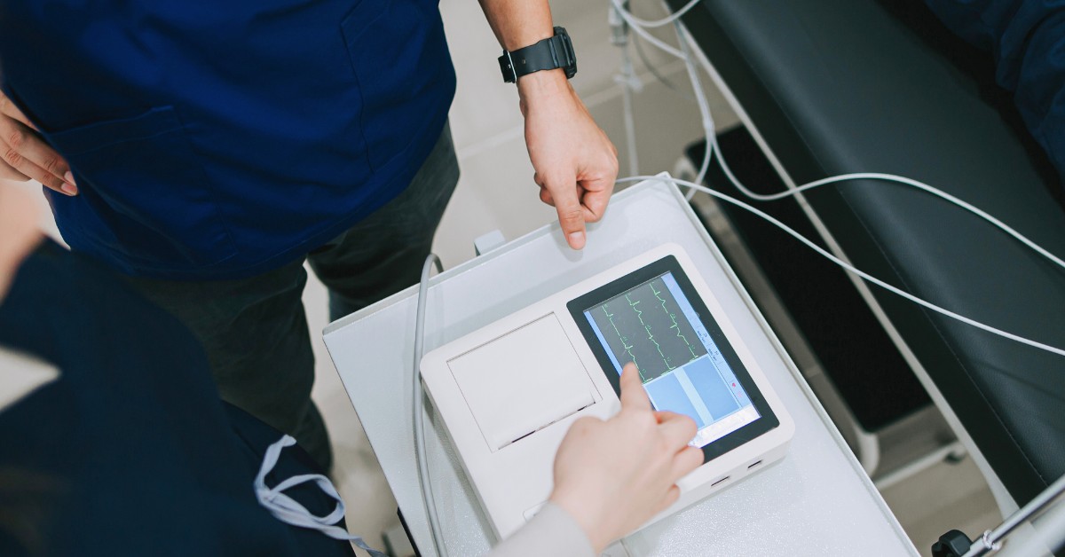 Doctor looking at ECG screen inside a unified cardiovascular service line