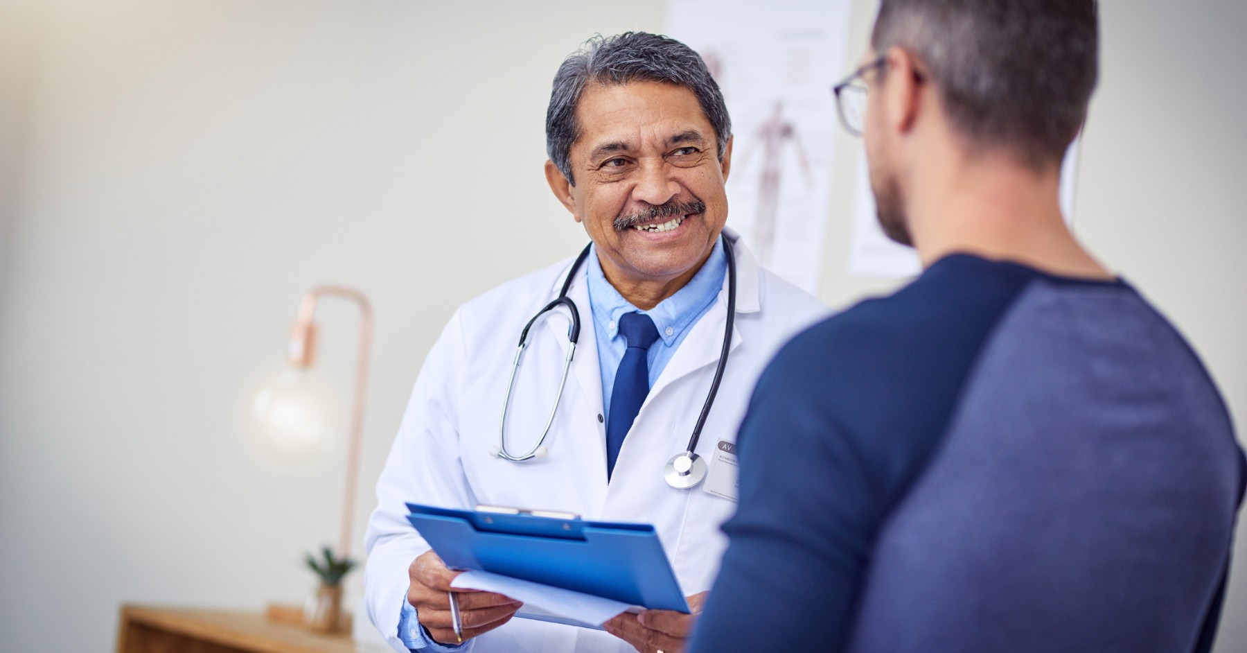 Mid-career cardiologist giving a patient consultation